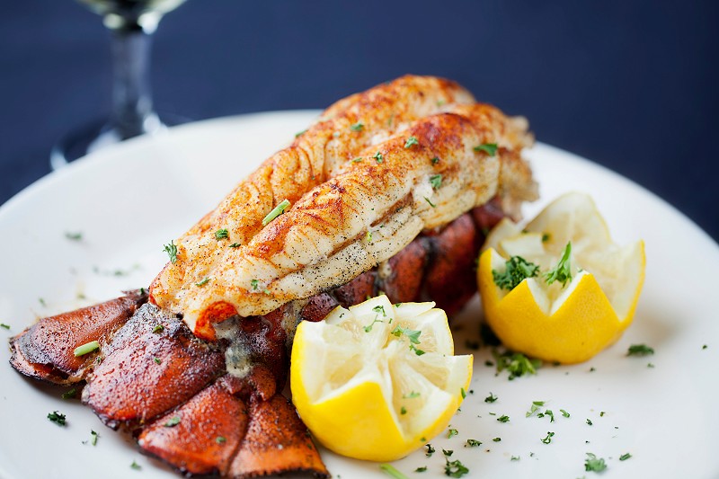 Large lobster tail served with white wine 155387793 5616x3744